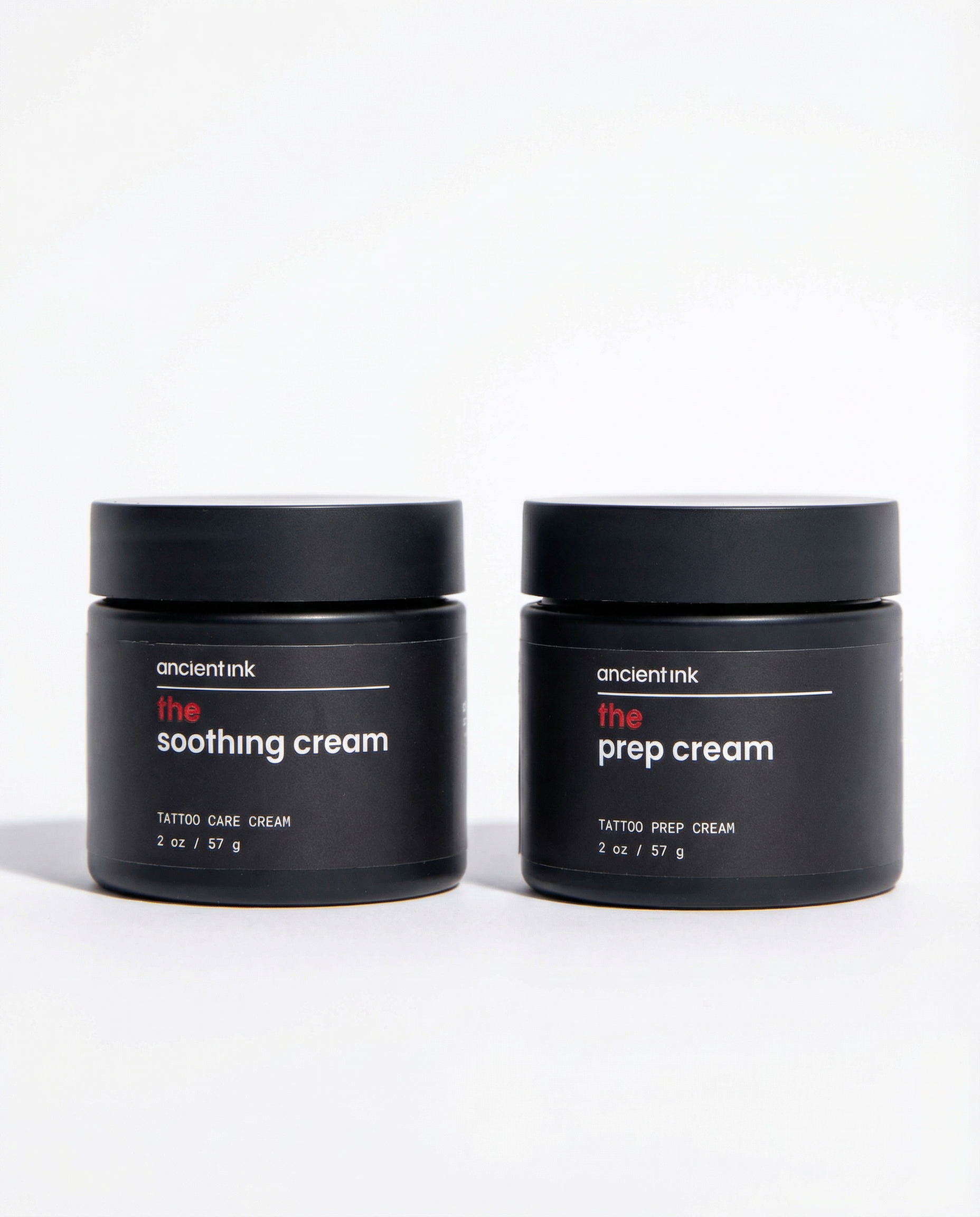 Two black jars of 'The Soothing Cream' and 'The Prep Cream' by ancient ink on a white background.